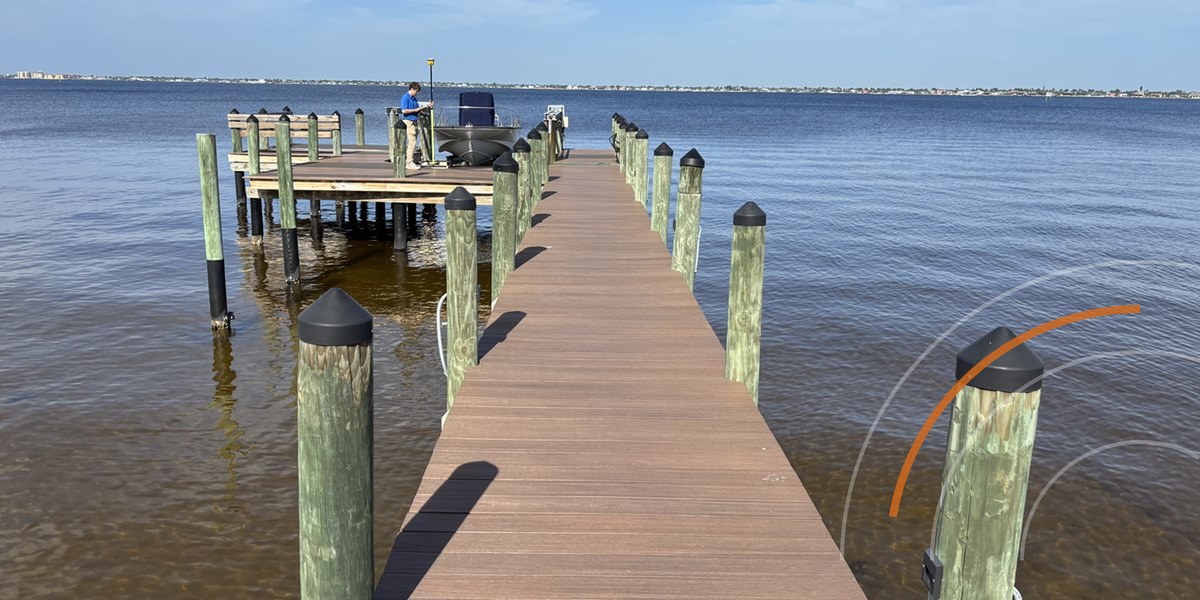 Blue Arc engineer running a tidal survey off a completed dock on the Caloosahatchee, Southwest Florida